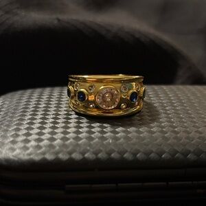 Gold cigar band style ring with Blue and Crystal Stones